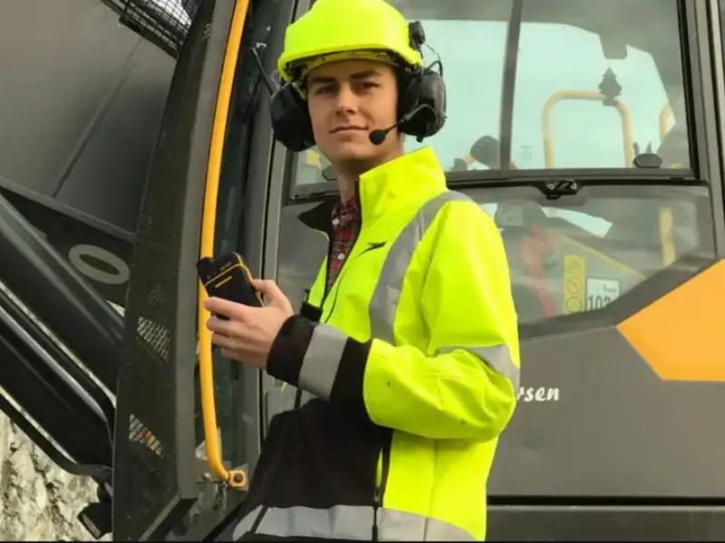 Construction workers with Push to Talk two way radio and earmuffs with push to talk