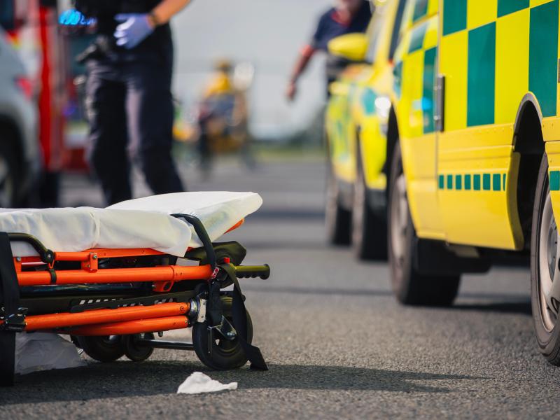 Ambulance with stretcher lying on the ground