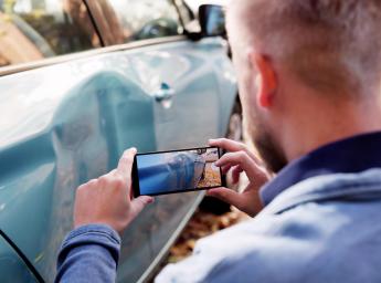 Insurance investigator captures evidence of car accidents using a smartphone.
