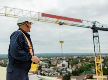 Crane operator using GroupTalk for full-duplex communication.