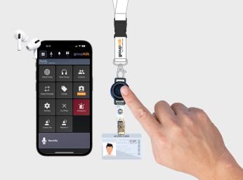 Lanyard with PTT button pressed by user to talk to colleagues.