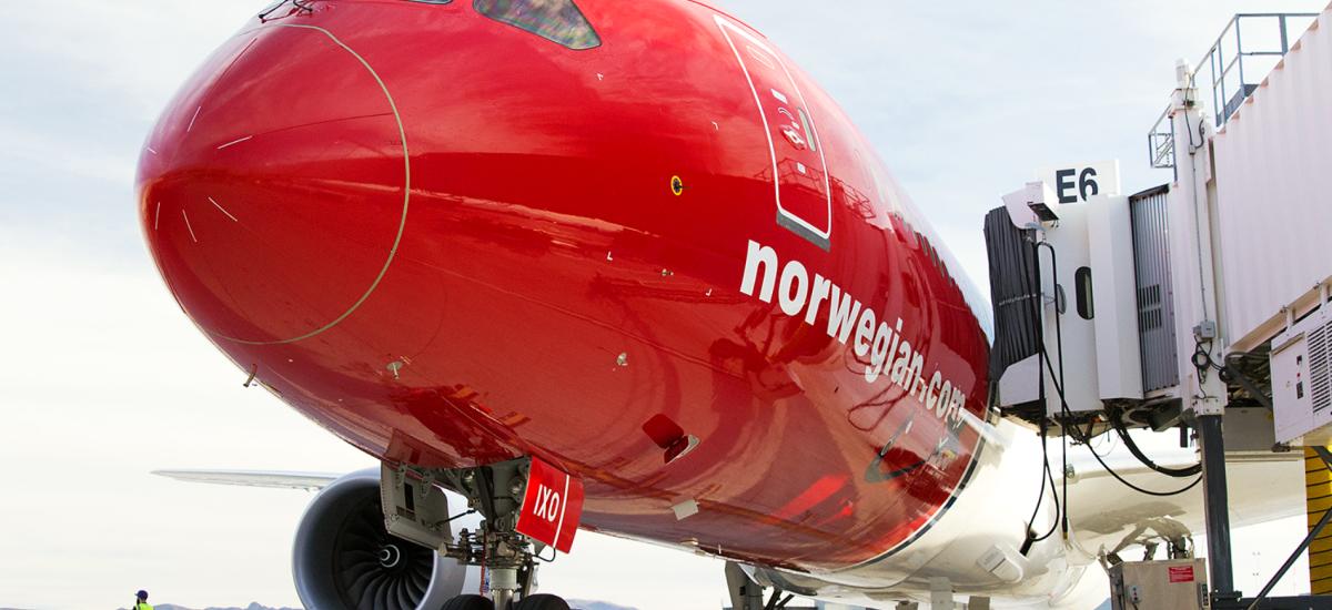Norwegian Air Shuttle aircraft flying in the air.