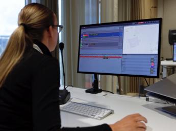 Woman operating GroupTalk for command and control operations.