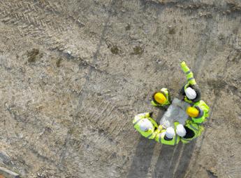 Construction team of six working together on site.