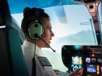 helicopter pilot talking to colleagues through peltor / ear muff