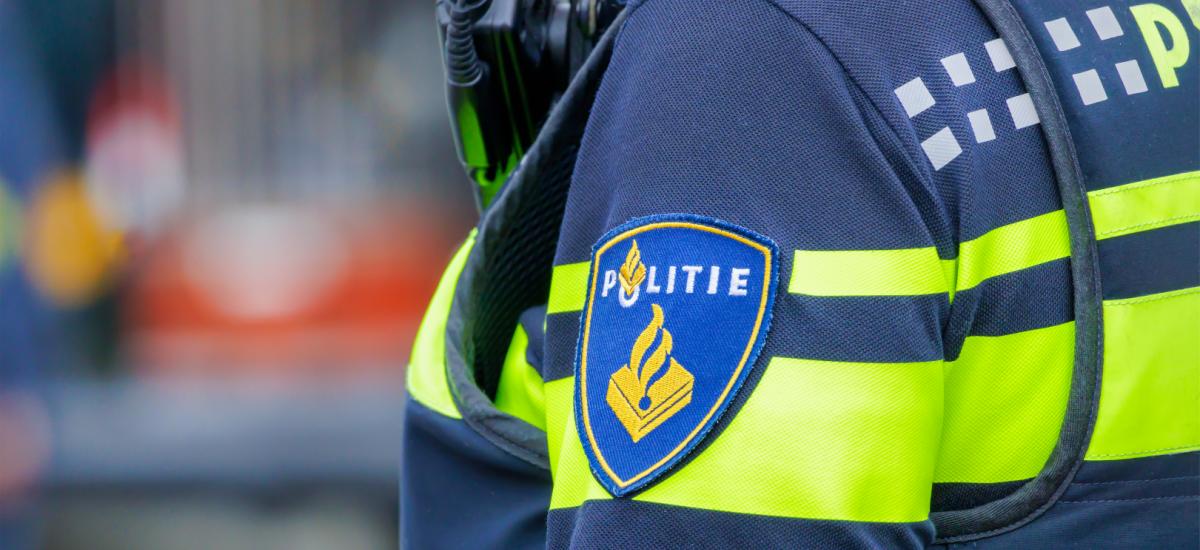 Close-up of Dutch police officer uniform with official badge.