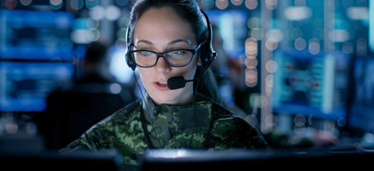 Female military worker at command and control center.