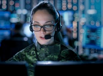 Female military worker at command and control center.