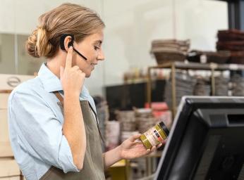 Retail worker using Jabra Perform 45 push-to-talk headset.