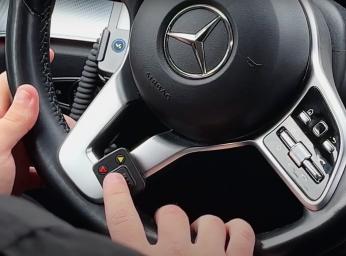 Taxi driver uses push-to-talk button in the car to talk to command and control center