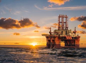 Oil rig offshore in the sunset at sea