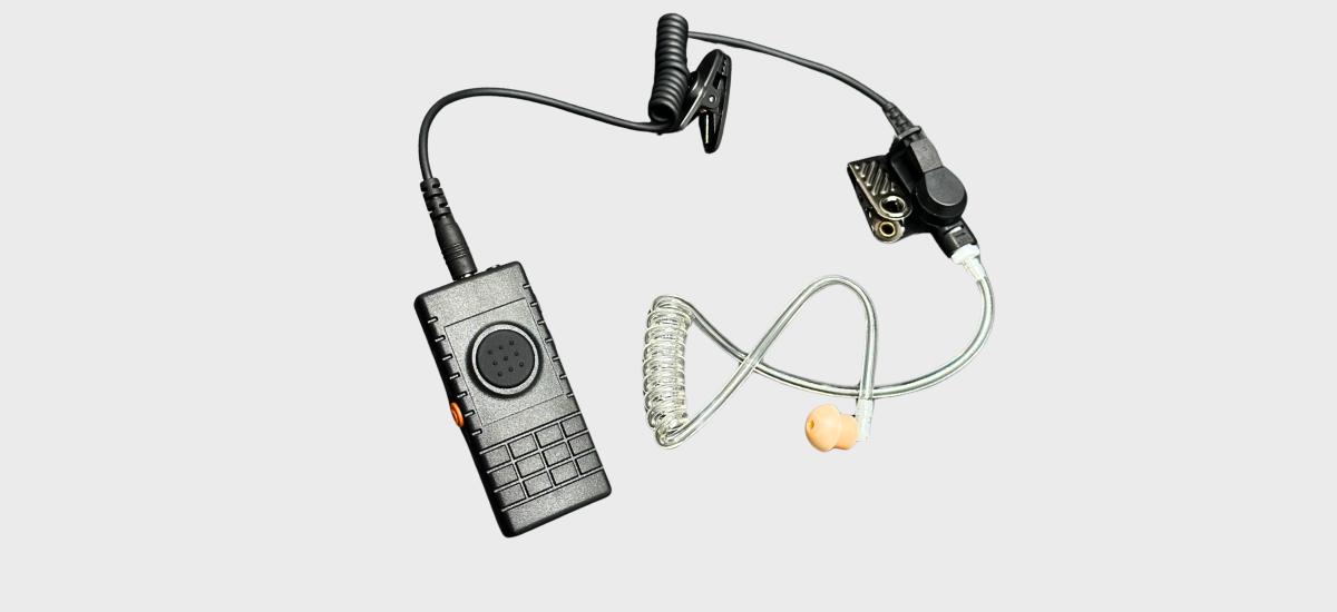 Discreet headset with Push to Talk and phone function buttons.